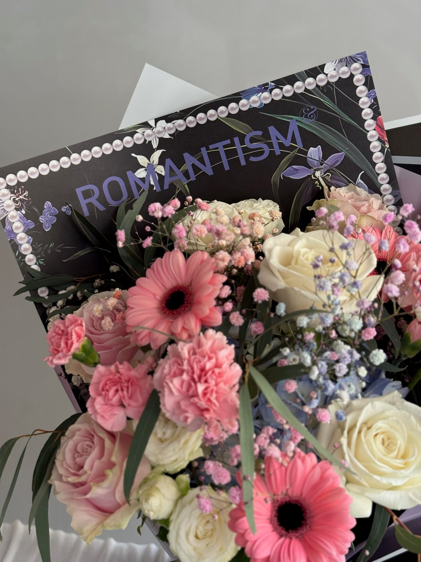 Black wrapping paper with white and pink flowers