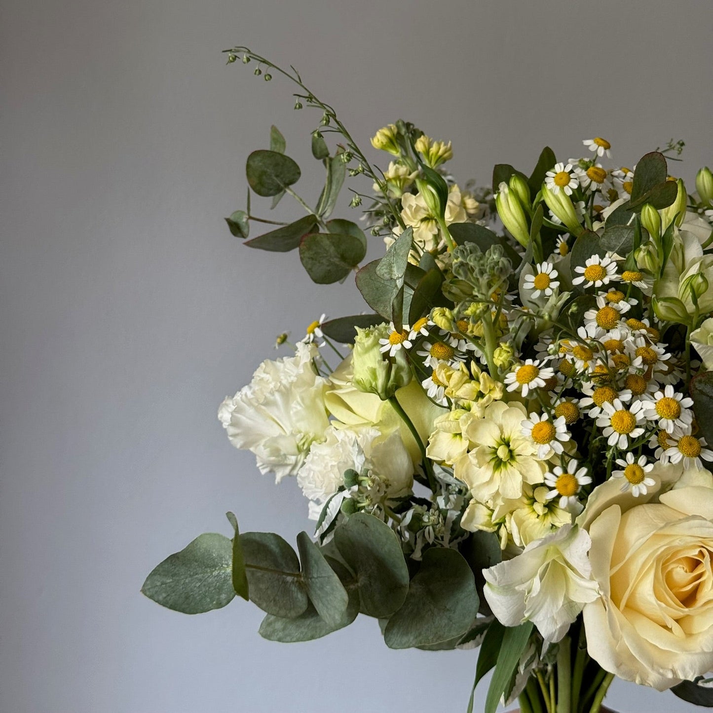 Bouquet of flowers with greenery on a gray background
