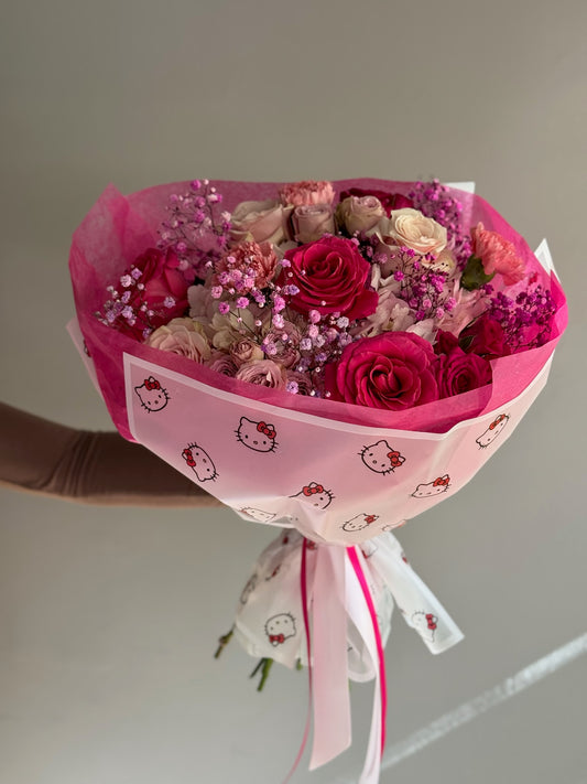 Pink fucsia bouquet with hello kitty wrapping on grey background
