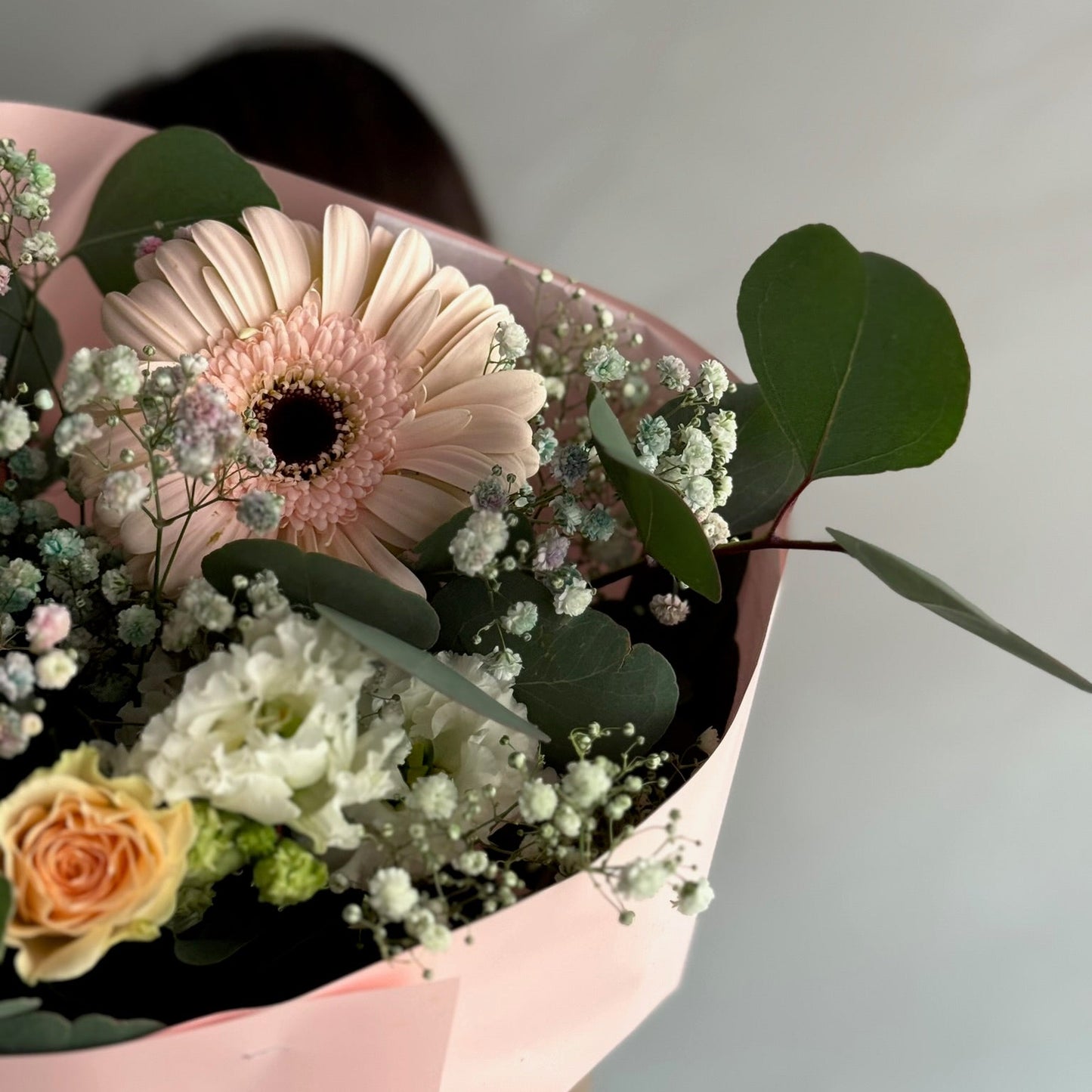 Bouquet of flowers in a pink box with a blurred background