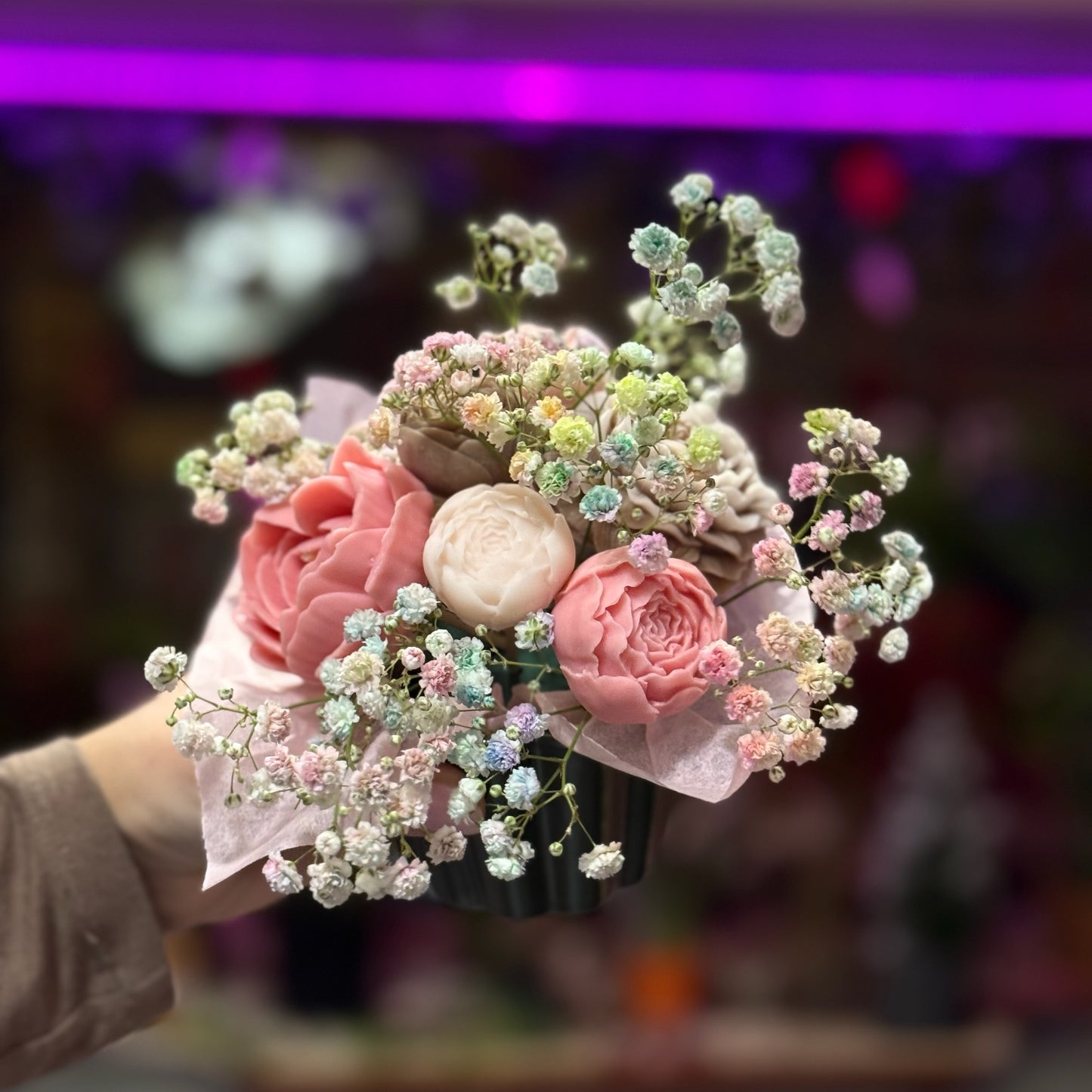 Bouquet of flowers held by a person with a blurred background