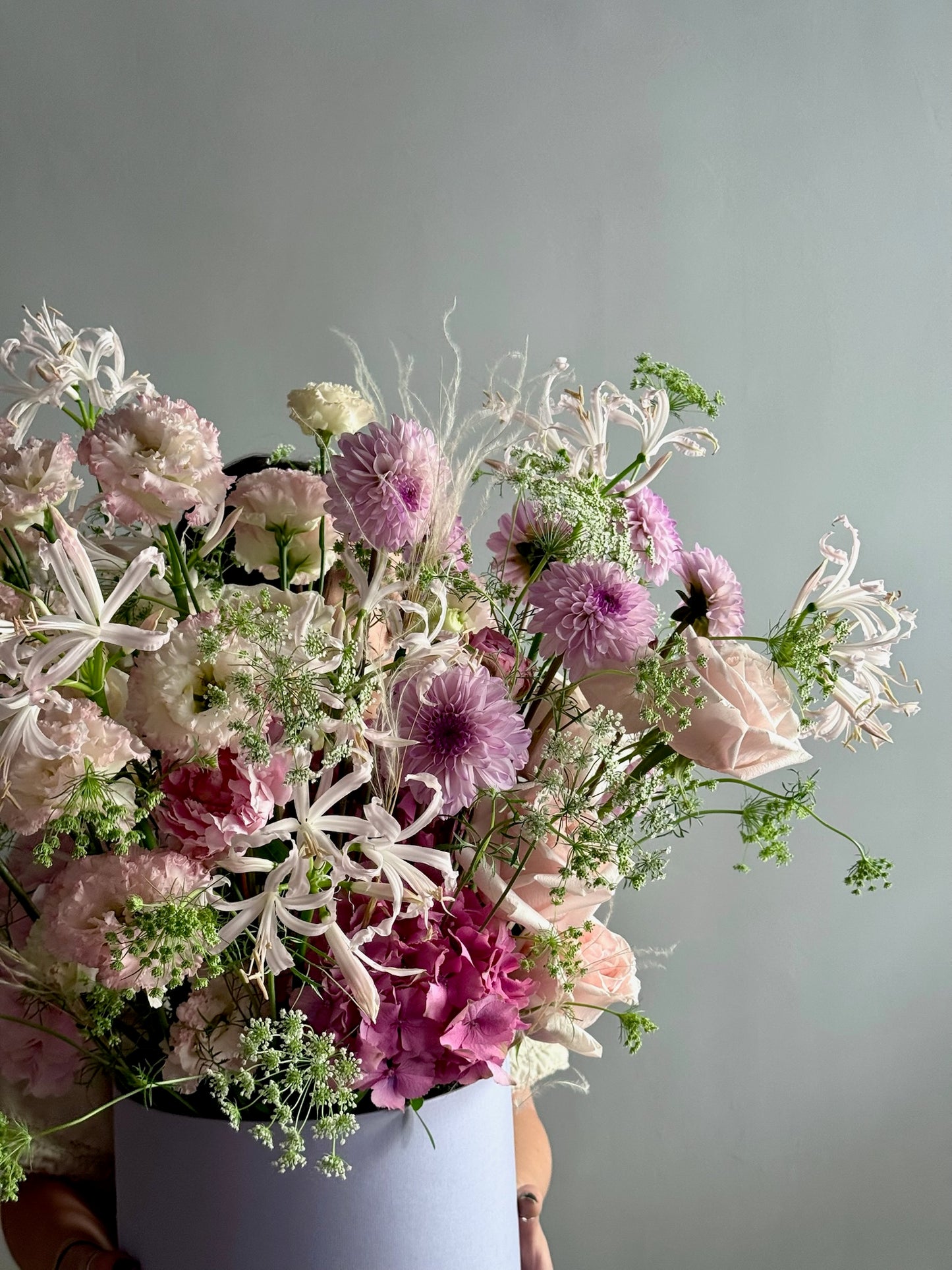 Bouquet of flowers with pink and white tones against a gray background