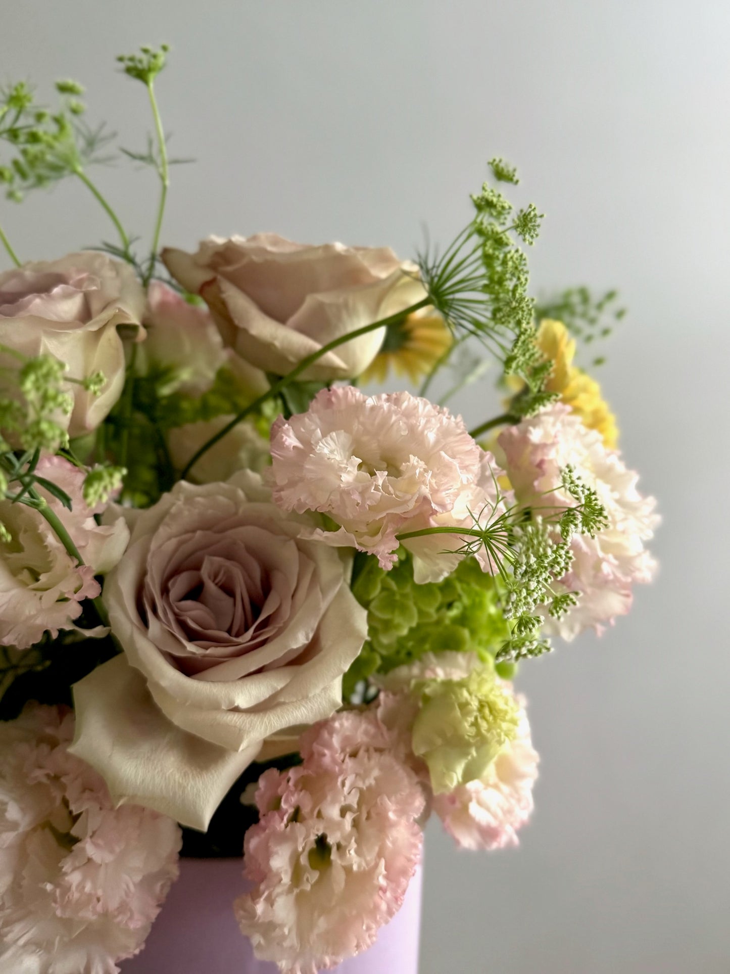 Bouquet of flowers with pink and white tones on a light background