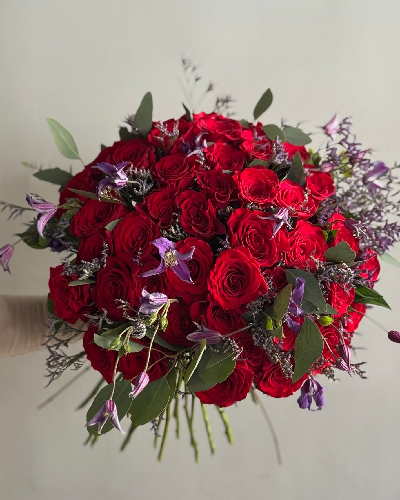 Very big bouquet with red rosesand purple flowers