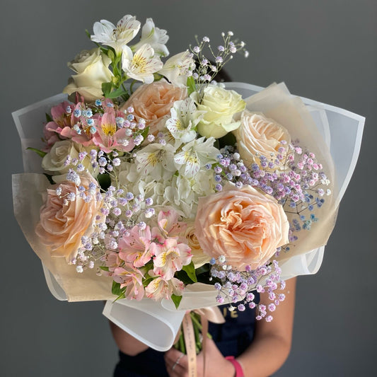 Bouquet of flowers held against a dark background