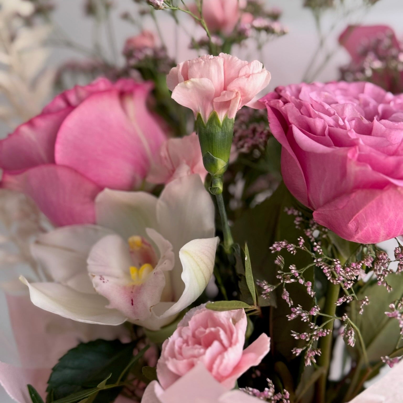 Bouquet of pink and white flowers with a blurred background