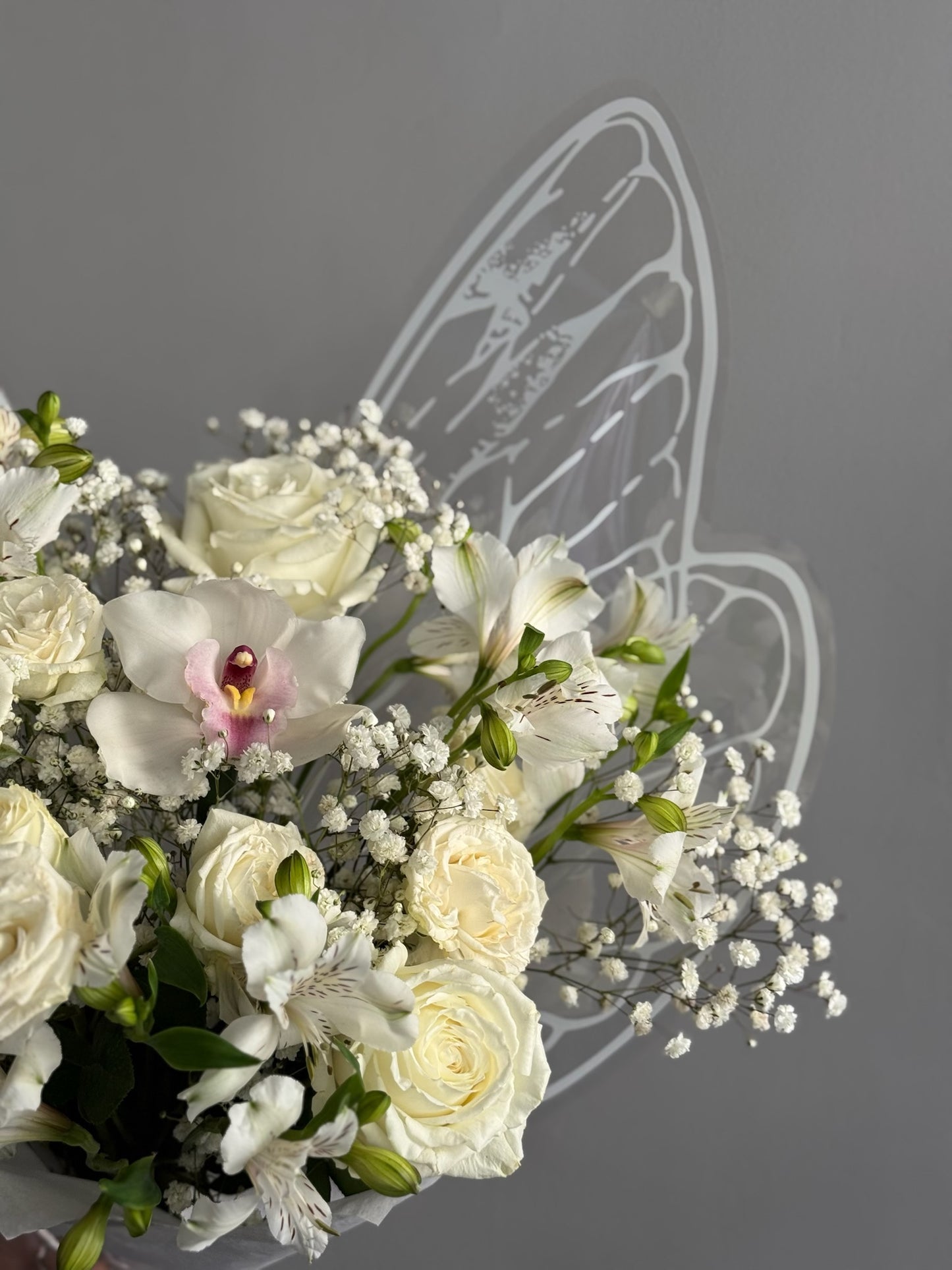 White flowers in floral bouquet with butterfly wrapping 