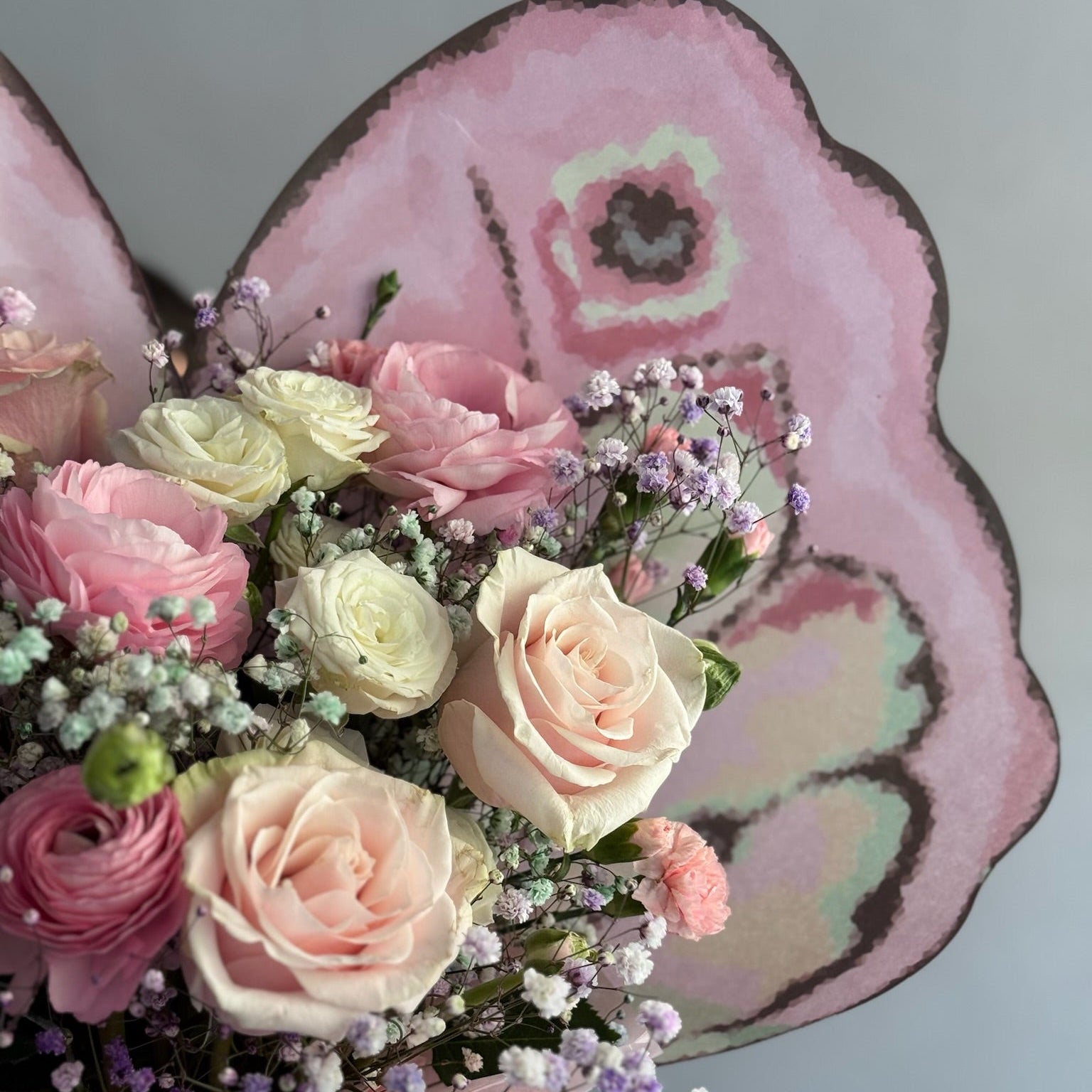 Butterfly wrapping with pink flowers in a bouquet
