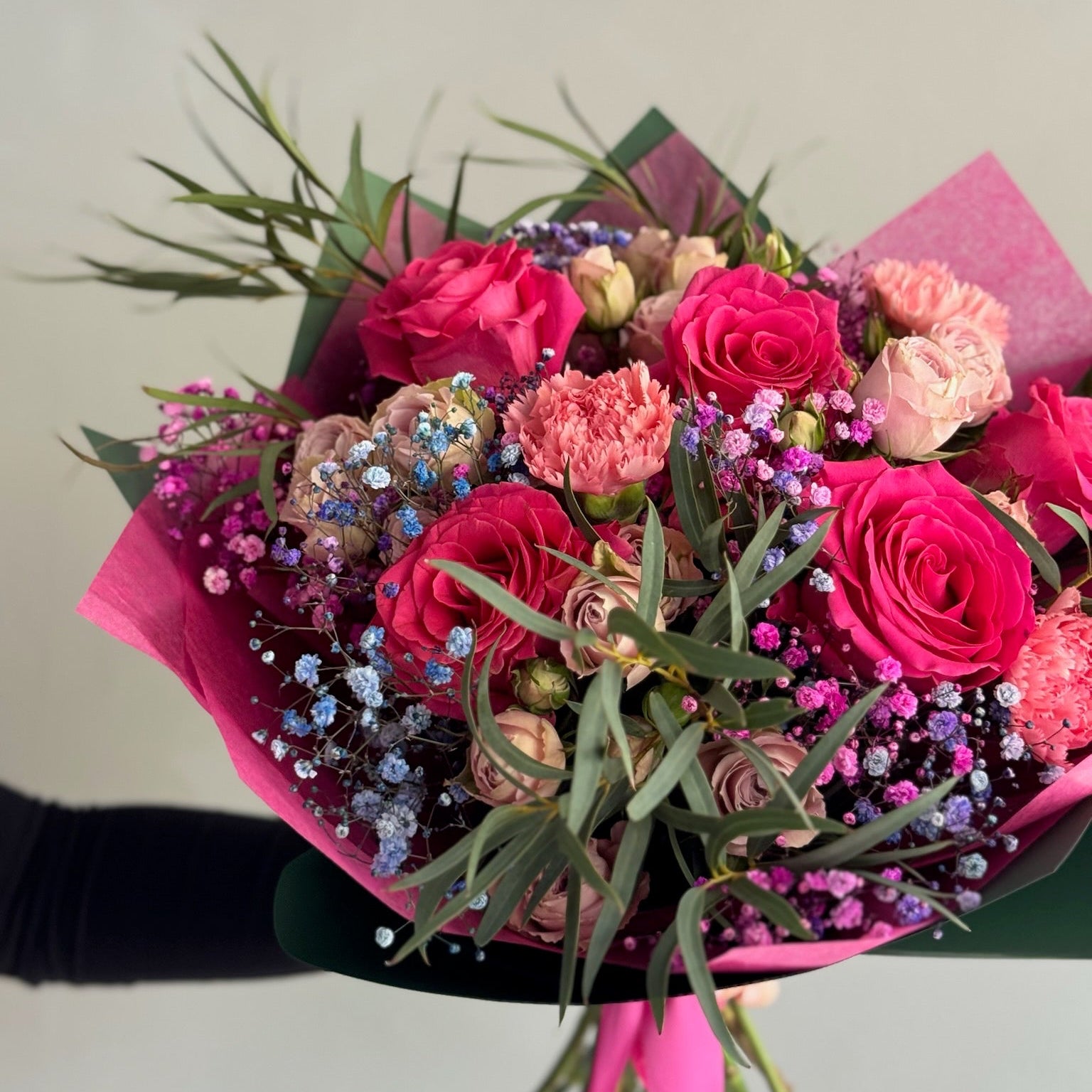 Fucsia bouquet with flowers on grey background 
