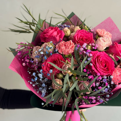 Fucsia bouquet with flowers on grey background 