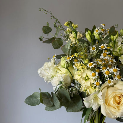 Bouquet of flowers with greenery on a gray background