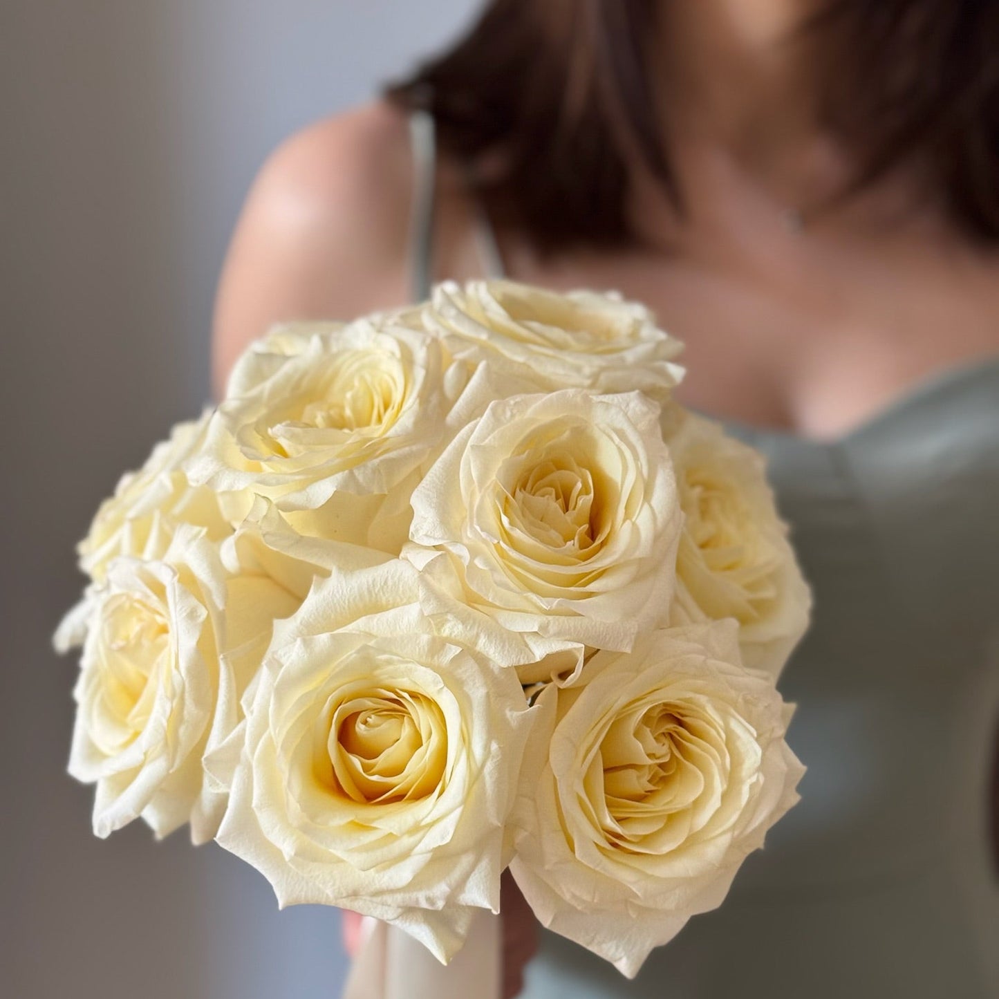 White roses in bridal bouquet held by person