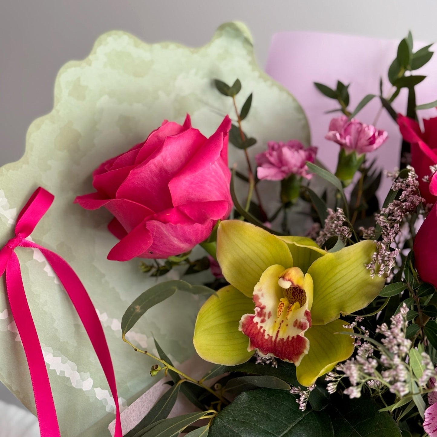 Bouquet of flowers with pink and green colors on a light background
