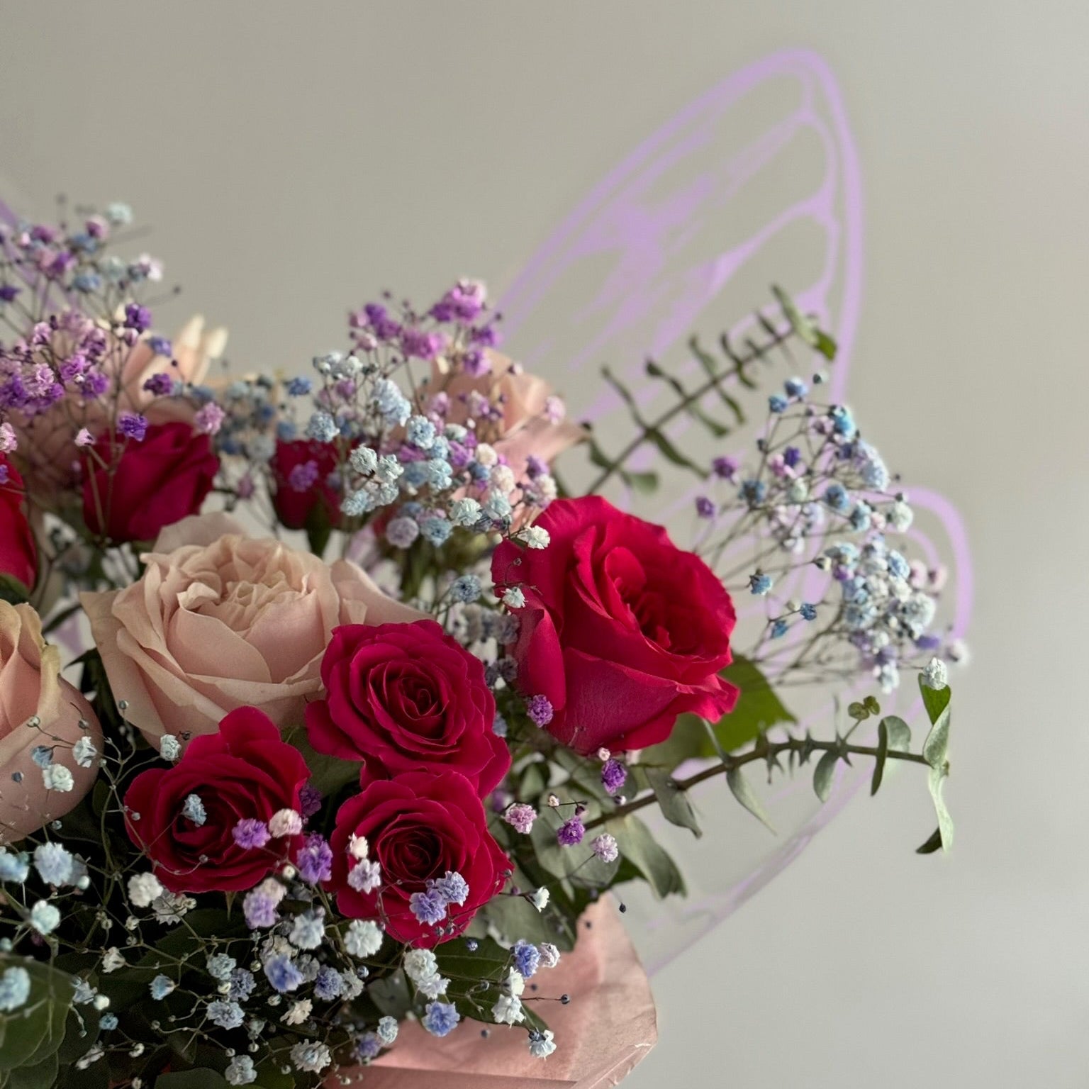 Pink flowers in bouquet ith butterfly wrapping paper