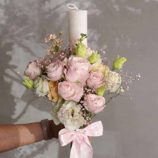 Wedding candle with roses and flowers against grey background 