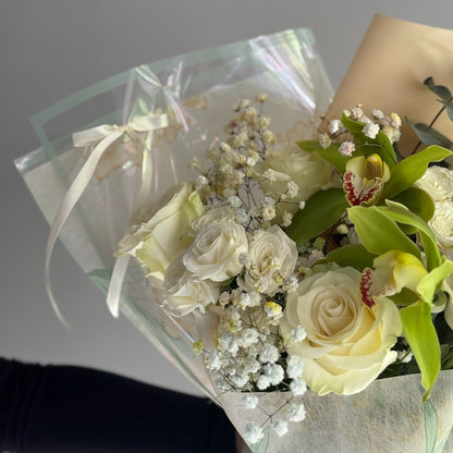 White roses and green orchids in bouquet