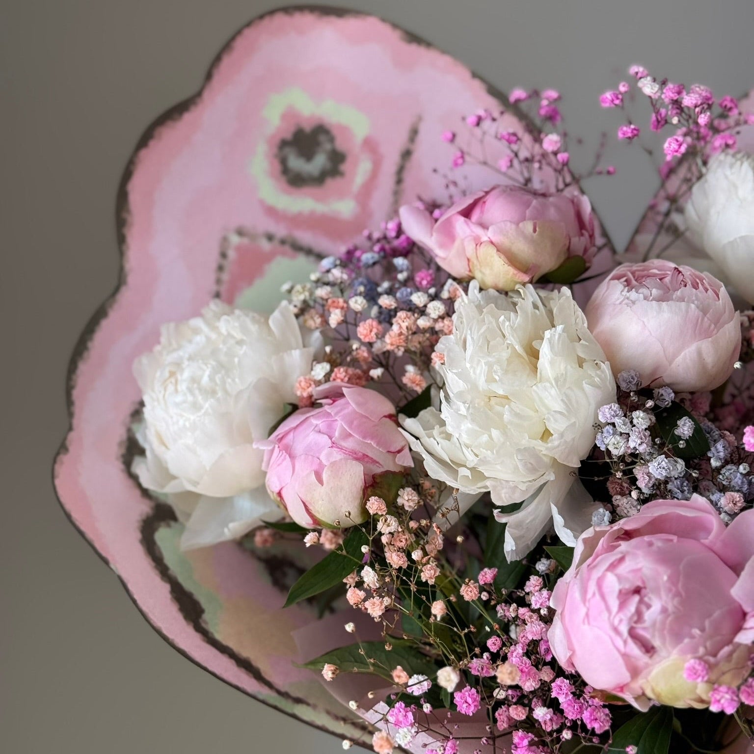 Pink bouquet with peonies on grey background 