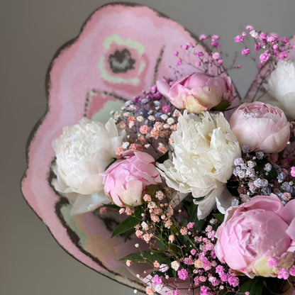 Pink bouquet with peonies on grey background 