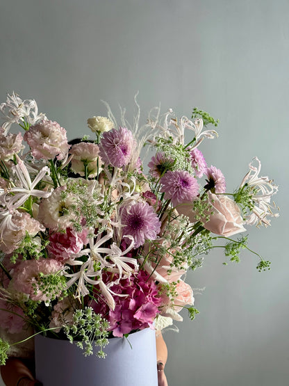 Bouquet of flowers with pink and white tones against a gray background