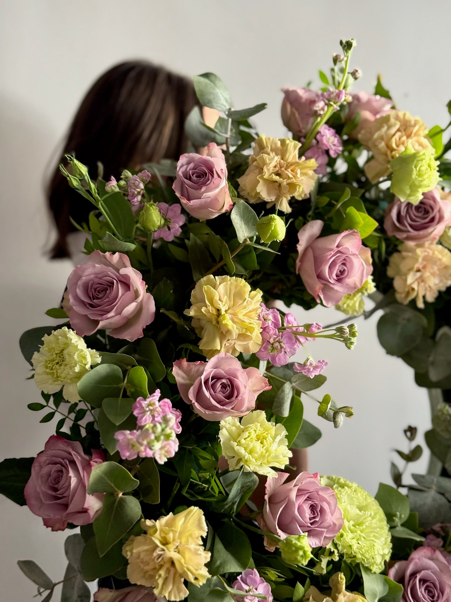 Bouquet of flowers with a blurred person in the background