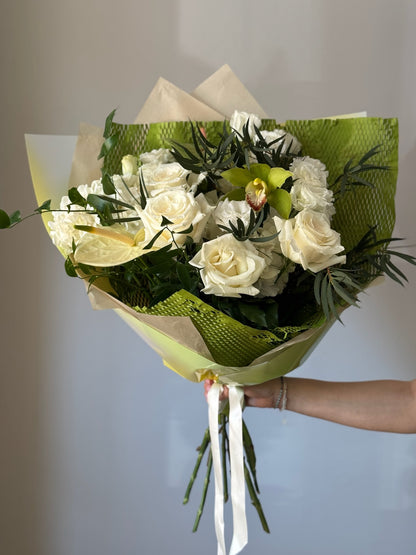 White flowers with greenery in a big bouquet on grey background 
