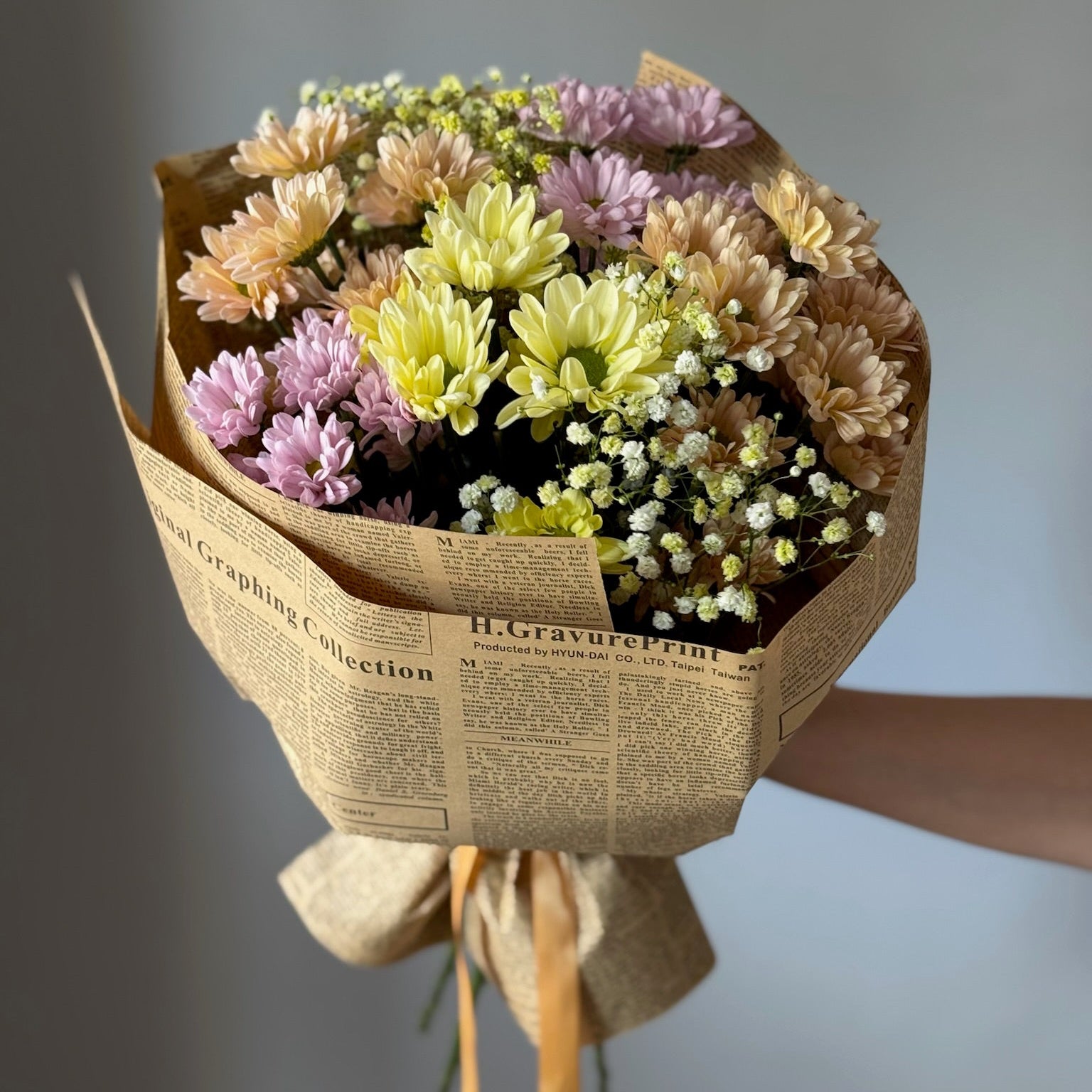 Colorful flowers in big bouquet on grey background 