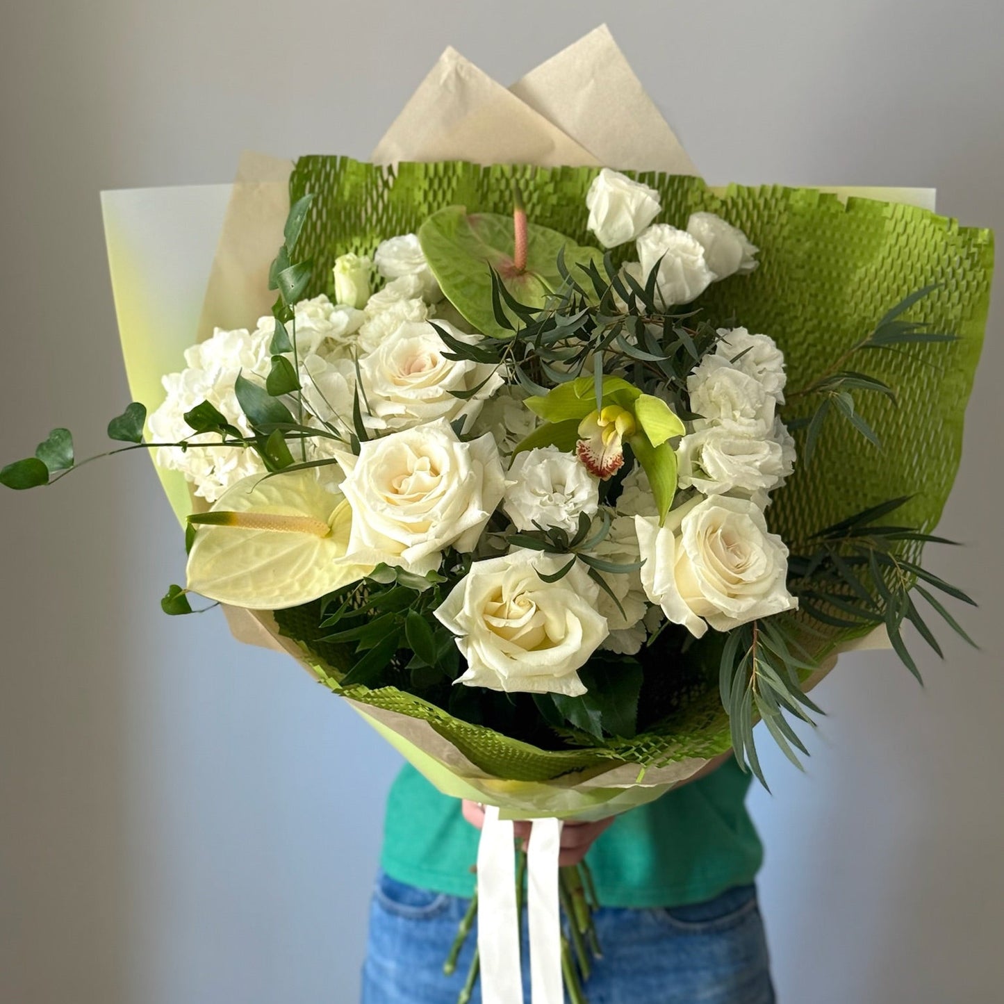 Big bouquet with white and green flowers on grey background 