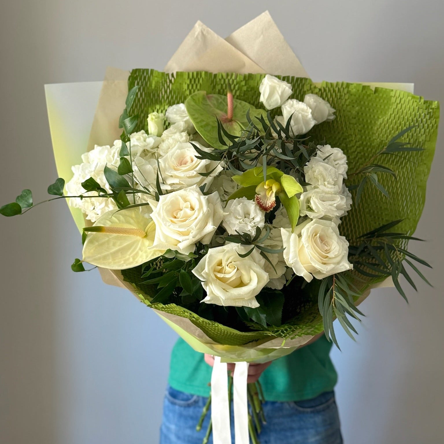 Big bouquet with white and green flowers on grey background 