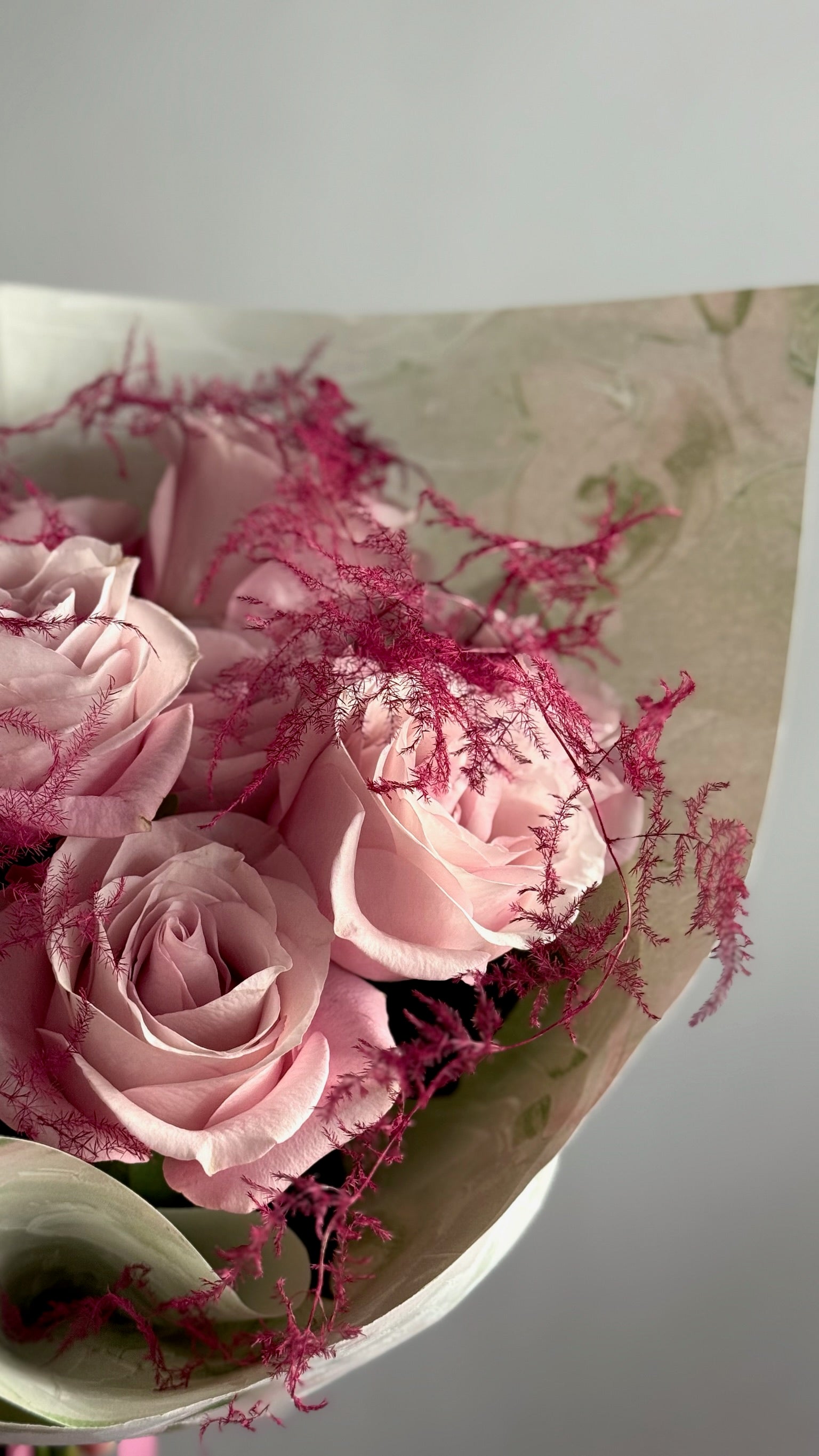Bouquet of pink flowers with green leaves on a white background