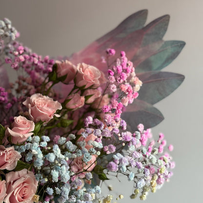 Bouquet of pink roses and baby's breath with a white background