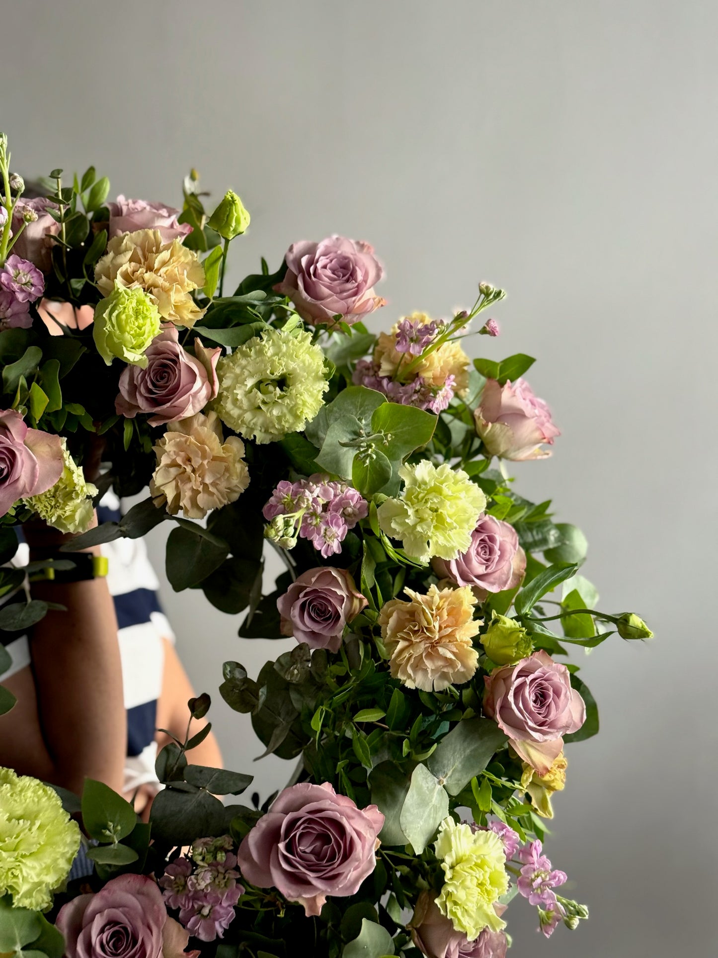 Bouquet of flowers with pink, green, and yellow colors against a neutral background
