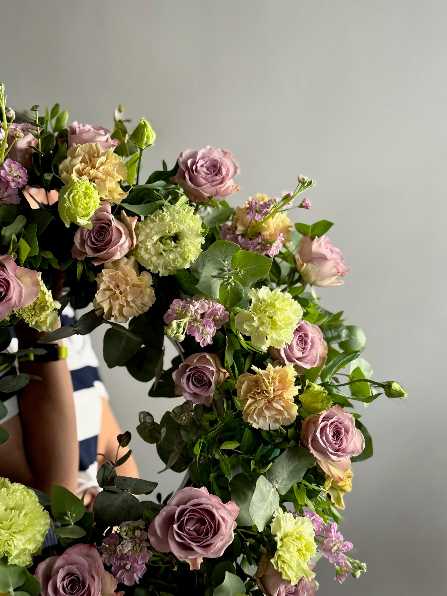 Bouquet of flowers with pink, green, and yellow colors against a neutral background