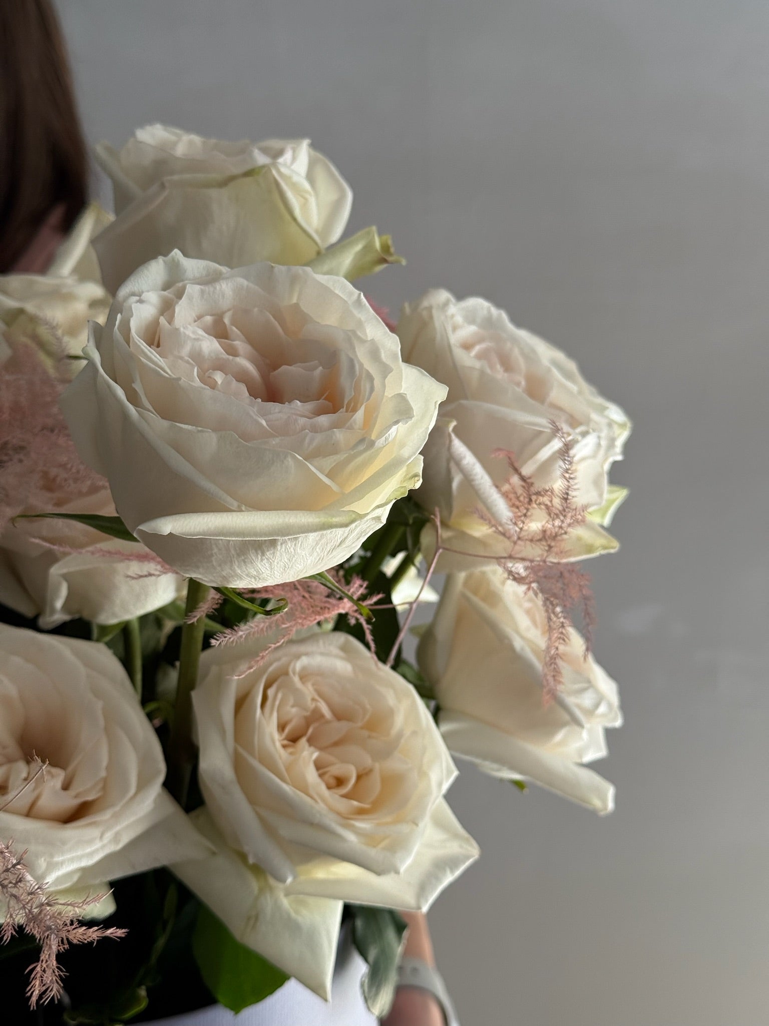 Bouquet of white and light pink roses on a neutral background