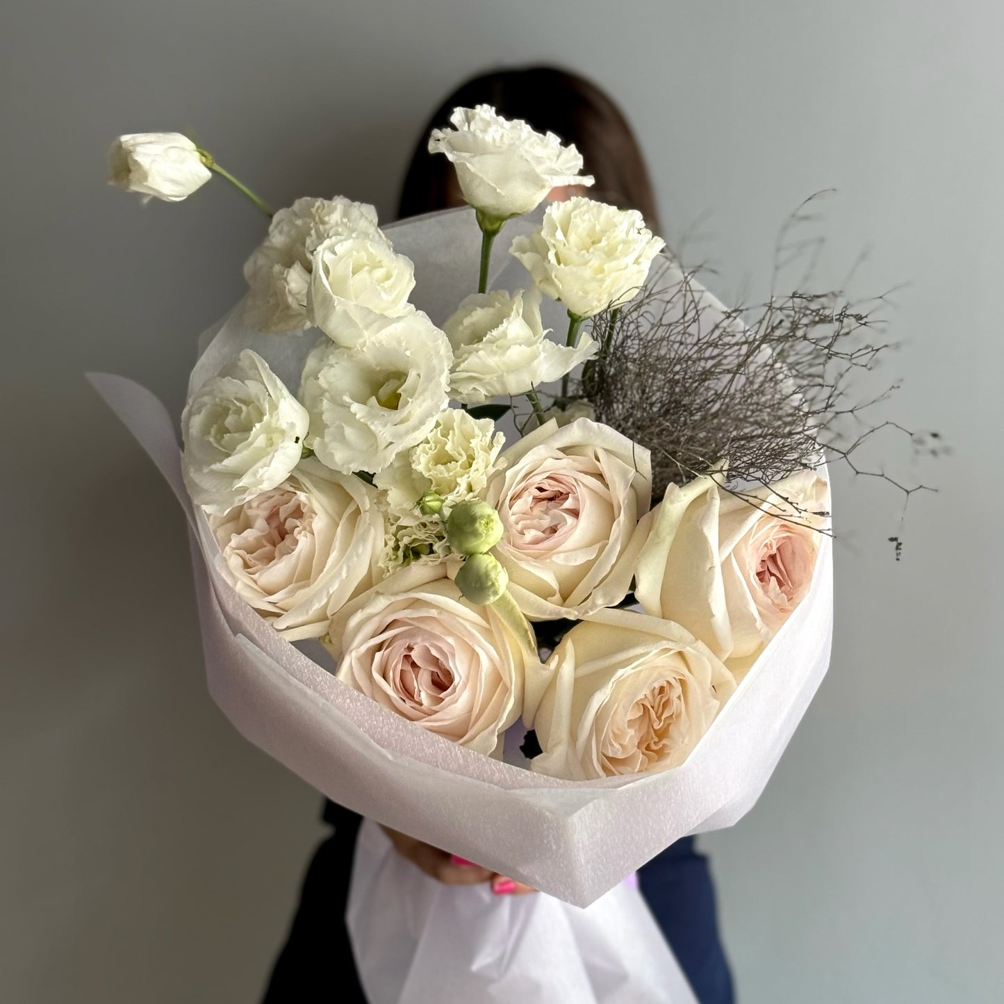White roses in a bouquet on grey background 