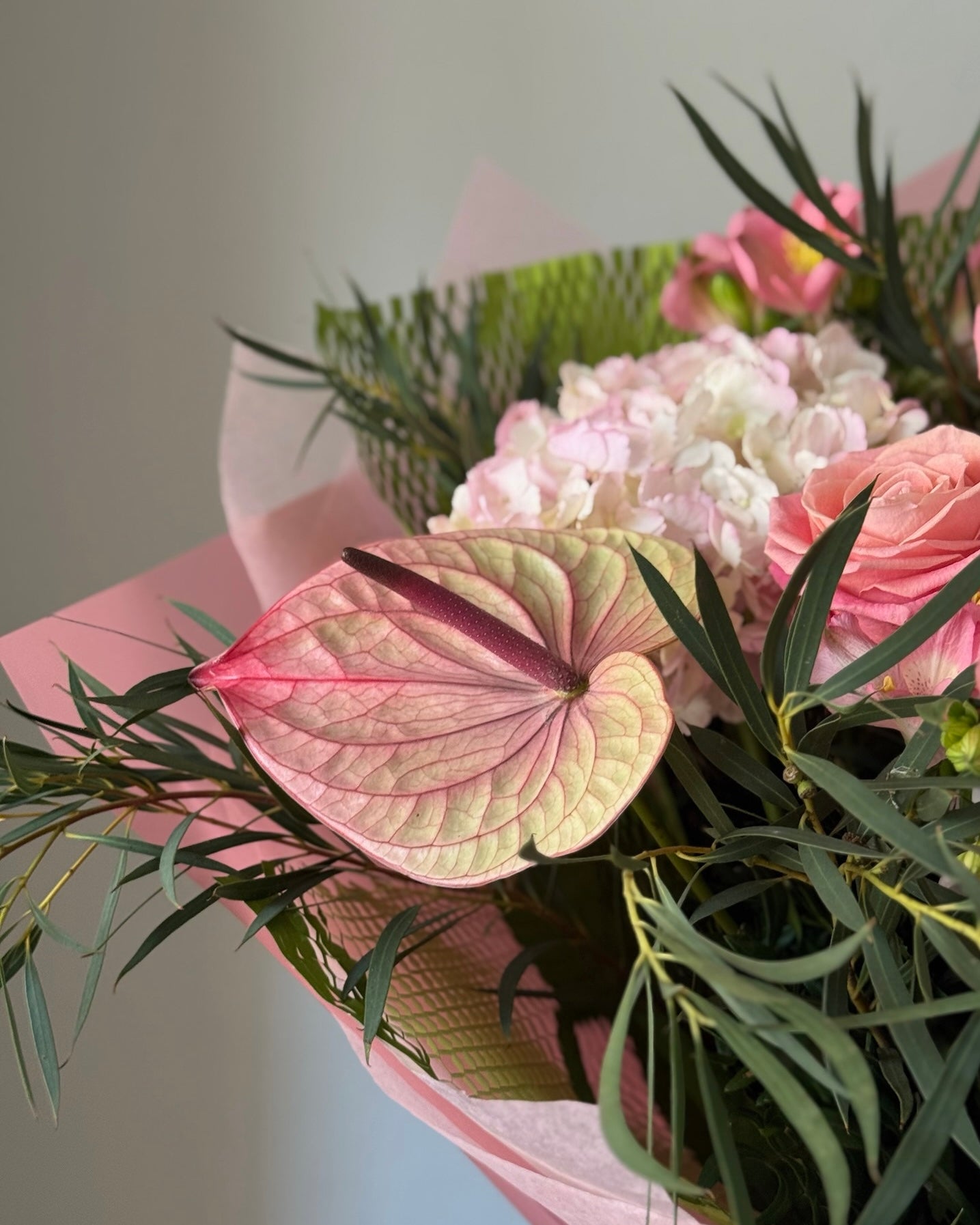 Pink flowers in bouquet on grey background 