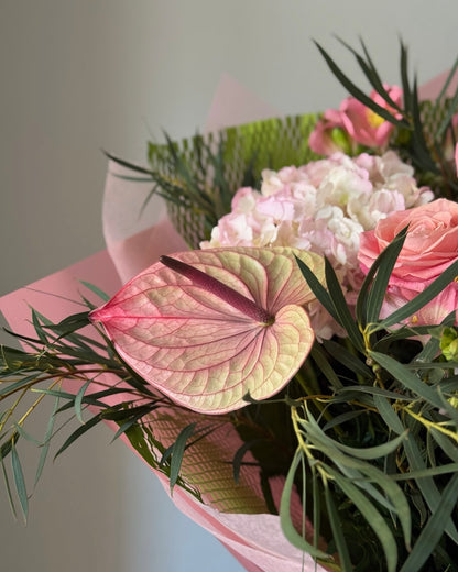 Pink flowers in bouquet on grey background 